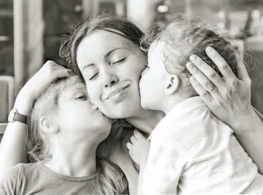 kids giving Natalie kisses